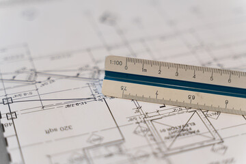 Architectural Scale Ruler with paper blueprints plans for new building