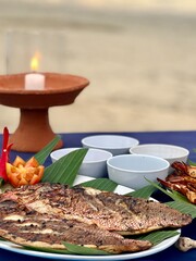 food and candles on the beach