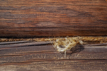 A fragment of the wall of an old wooden house in close-up