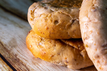 Closeup a couple of homemade walnut breads on the wooden shabby thick table. Simple, organic and minimal conceptual image.