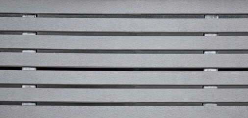 Small gray plaster design background next to horizontal steel