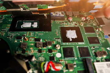 Thermal paste compound squeezing on processor of notebook. Thermal grease for better cooling of...