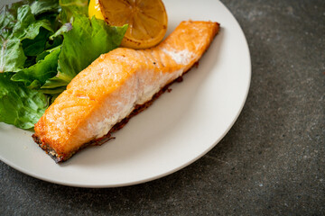 fried salmon steak with lemon and vegetable