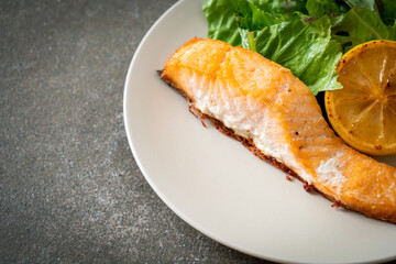 fried salmon steak with lemon and vegetable