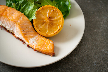 fried salmon steak with lemon and vegetable
