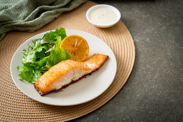 fried salmon steak with lemon and vegetable