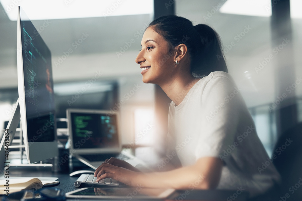 Poster Life as a coder. Shot of a woman using a computer in a modern office.