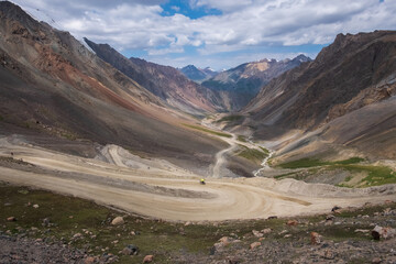 Dangerous gravel mountain road to Kumtor gold mine. Serpentine road to Barskoon mountain pass. Travel, tourism in Kyrgyzstan concept.