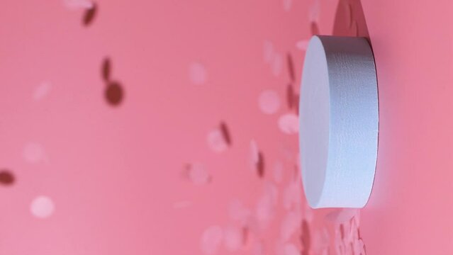 Cosmetics product blue mockup with confetti falling on pink background, vertical