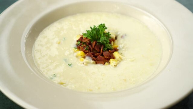 corn soup with crispy bacon on plate