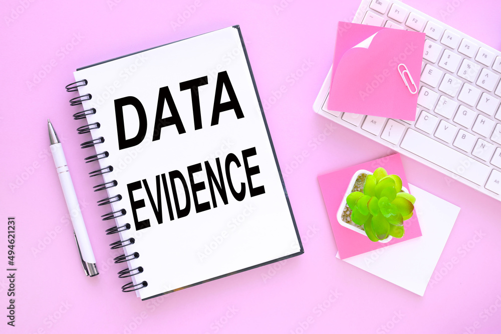 Poster data evidence - business concept, text on a notebook with a spring on a pink background