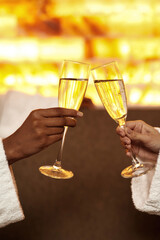 Cropped of women toast champagne in glasses in spa