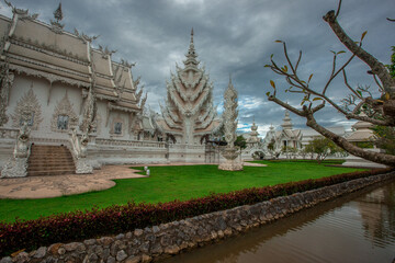 background Wat Rong Khun The White Temple and pond with fish, in Chiang Rai, Thailand