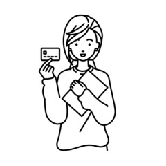 立って書類とカードを手に持つリモートワークの女性