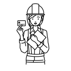 立って書類とカードを手に持つ工事現場の女性