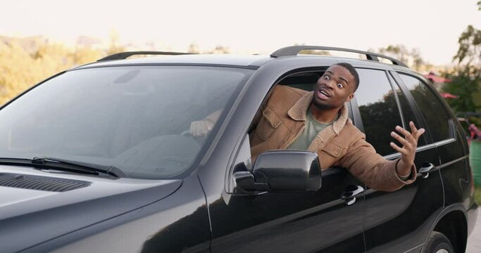 Angry black driver behind the wheel of a car