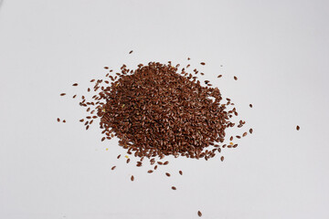 A bunch of flax seeds on a white background, very useful seeds for cooking