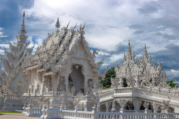 background Wat Rong Khun The White Temple and pond with fish, in Chiang Rai, Thailand