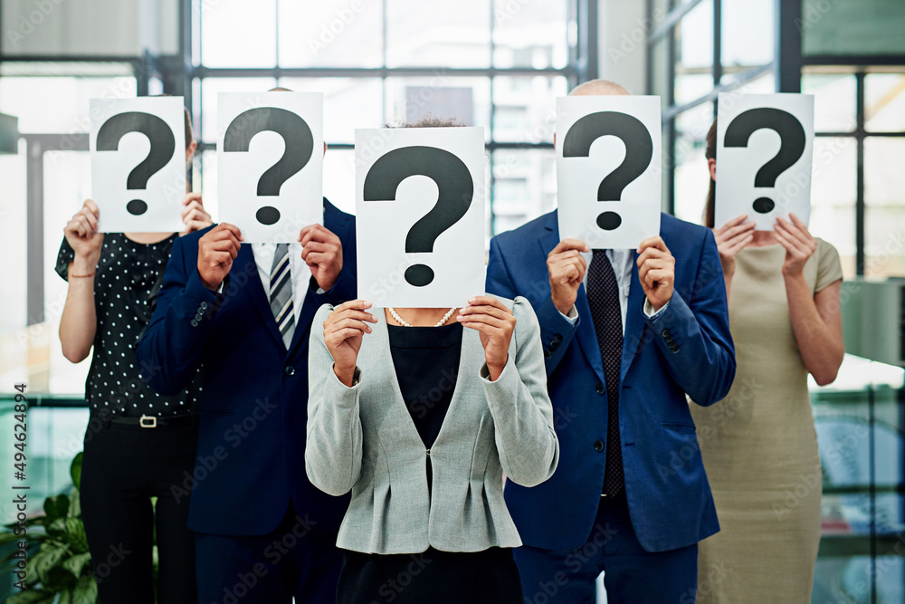 Poster whos in charge here. cropped shot of a group of unidentifiable businesspeople holding placards with 