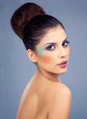 She uses makeup to highlight her best features. Cropped shot of a beautiful young woman wearing bold makeup.