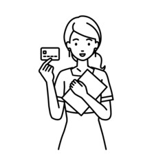 立って書類とカードを手に持つエステ店員・接客・受付の女性