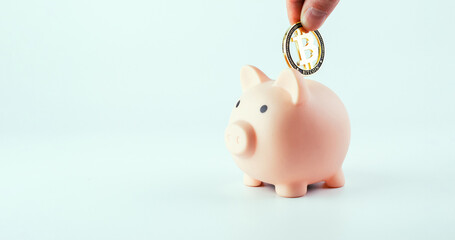 Save currency bitcoin. Pink pig bank with golden bit coin money BTC on white background. Save money...