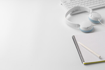 Minimalistic white workplace with keyboard and notebook