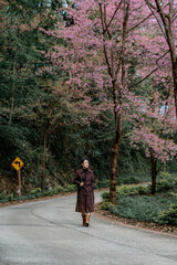 Fototapeta premium girl with bright pink cherry blossoms in winter