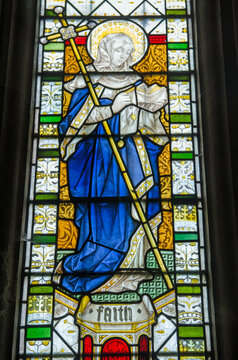 Stained glass window showing the virtue Faith