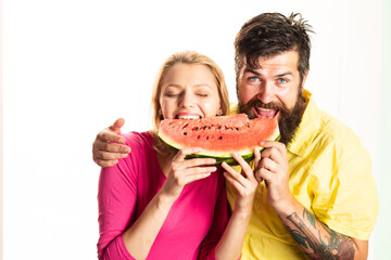 Funny cheerful couple holding slices of watermelon.