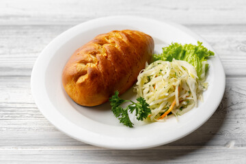 Traditional Russian pie or patty on white plate