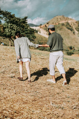 happy couples in the fields and mountains in summer