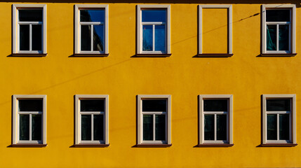 yellow house facade with ten windows