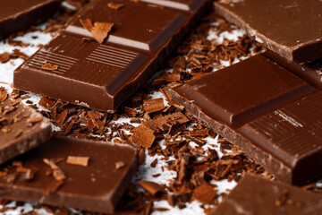Grated chocolate and pieces of tasty chocolate on table