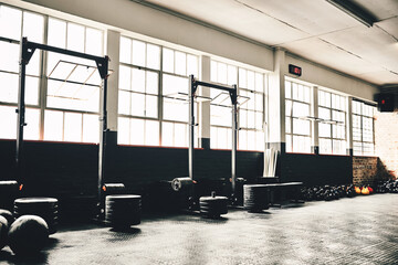 They are ready to get tested on. Shot of the interior of a health club full of gym equipment ready for use.