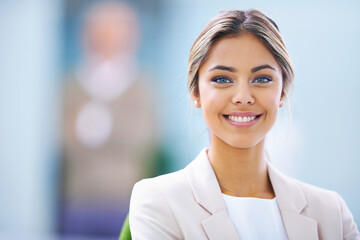 Total job satisfaction. Portrait of an attractive young businesswoman standing in an office.