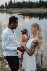 Carefree multiethnic family having fun together outdoors in daytime