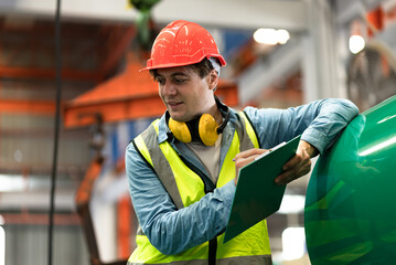 Smile engineer or foreman hard work with clipboard at factory	