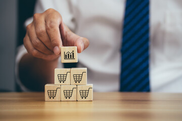 Man hands flips cube with icon target goal shopping cart symbol, sale volume increase make business...