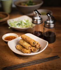 Vegetarian Vietnamese pancakes rolled into tubules on the table