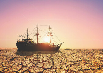 Boats on a barren land. A ship on a broken land. The concept of drought, global warming and the...