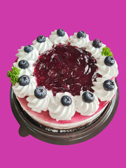 blueberry raspberry cake with delectable sauce on isolated purple background