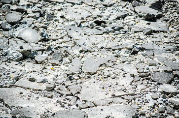 Crack broken concrete street surface in close up.
