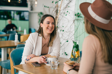 women friends on coffee break at cafeteria