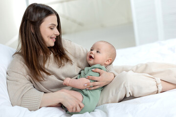 Fototapeta na wymiar Mom and baby. Beautiful woman with a baby at home. High quality photo