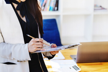 Young economists or accountants or financiers and investors are reviewing budget documents to study...
