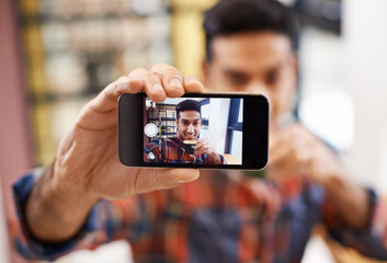 Coffee shop selfie. Cropped shot of a handsome young man taking a selfie.