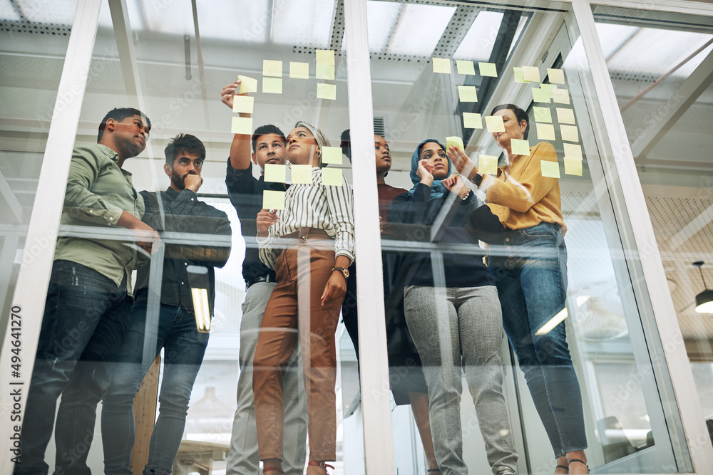 Aufkleber working through their best concepts. shot of a group of businesspeople brainstorming with notes on a