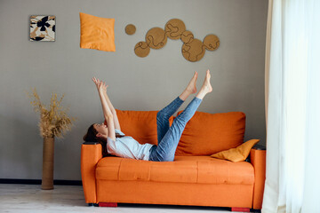 beautiful woman on the orange couch in the rest room posing unaltered