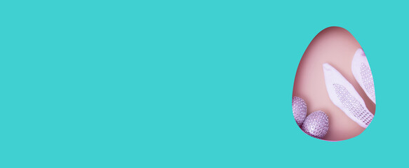 Banner with copy space and Easter egg cut out and decoration with bunny ears and eggs. Creative Easter holiday greeting card